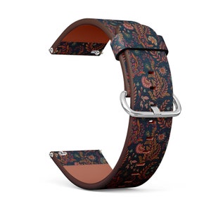 May include: A watch band with a floral pattern. The band features a dark blue background with a repeating pattern of orange, red, and green flowers and leaves. The band has a brown underside and a silver buckle.