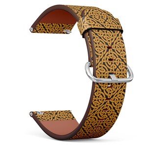May include: A brown leather watch band with a gold and black Celtic knot pattern. The band has a silver buckle.