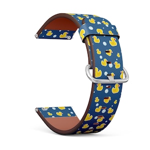 May include: A blue and brown leather watch band with a pattern of yellow rubber ducks. The band is designed for a smartwatch.