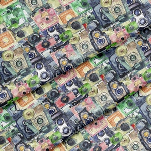 May include: A seamless pattern featuring vintage cameras in various colors and styles, including green, blue, red, and brown. The cameras are arranged in a random pattern, creating a whimsical and nostalgic feel.
