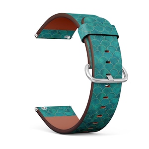 May include: A teal and gold leather watch band with a scale pattern. The band is designed for a smartwatch.