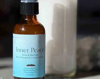 May include: A brown glass spray bottle with a black cap and a light blue label that reads "Inner Peace". The label also states "Relax & Meditate, Reiki Charged & Crystal Infused". The bottle is 60ml. Light blue crystals are scattered around the bottle.