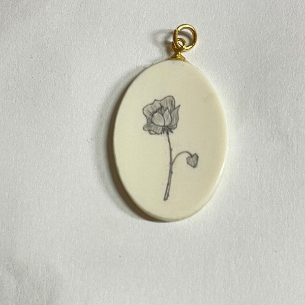 Vintage white coral 30 x 20 mm oval scrimshawed flower oval pendant 14 K gold plated metal parts circa 1970.  Free shipping.