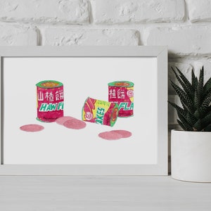 May include: Watercolor print of three cans and a box of haw flakes, a popular Chinese snack. The cans are red with green and yellow accents, and the box is yellow and red. Pink haw flakes are scattered around the cans.