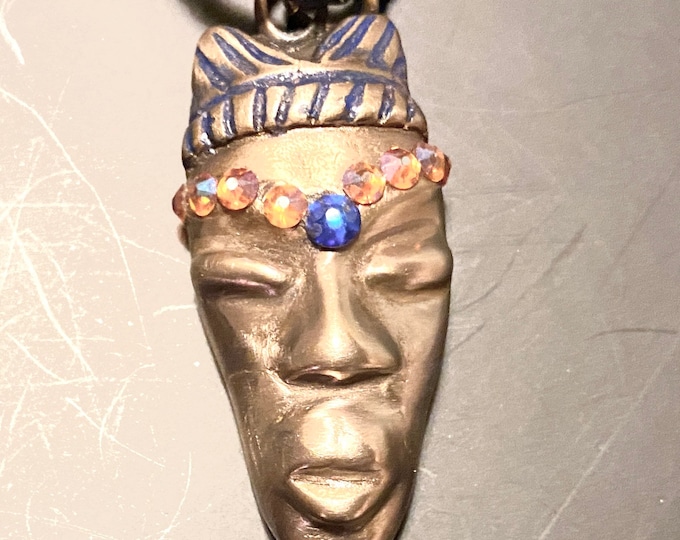 AC5. Handmade bronze African Queen, pendant hanging from 18” braided navy blue leather cord, Swarovski Crystals