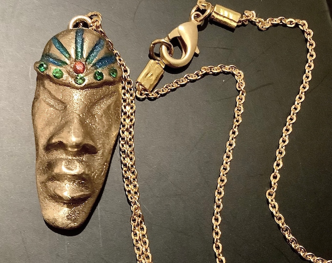 AC2. Bronze head of African King. Handmade of sand bronze, chain is 18” also in bronze, garnet, Swarovski Crystals