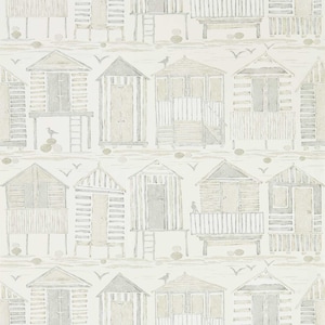 May include: A white background with a repeating pattern of gray and beige beach houses. The houses have different styles and some have ladders or balconies. The houses are on stilts and there are small gray birds and white seagulls flying around them.