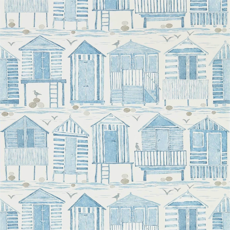 May include: A repeating pattern of blue and white beach houses with gray stones and seagulls on a white background.