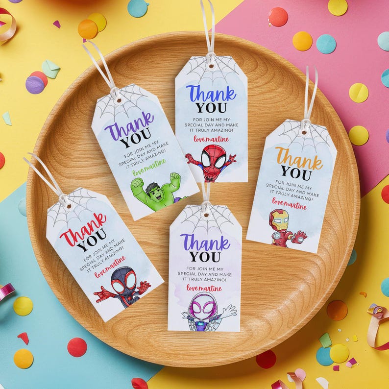 May include: Five colorful thank you tags with a spiderweb design. Each tag features a different superhero character, including Spider-Man, Iron Man, Hulk, and two versions of Spider-Woman. The text on the tags reads "Thank You" and "For join me my special day and make it truly amazing! love martine".