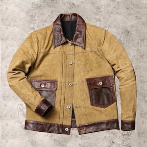 May include: A brown and tan jacket with a brown leather collar and pockets. The jacket has a button closure and a brown leather trim around the bottom.