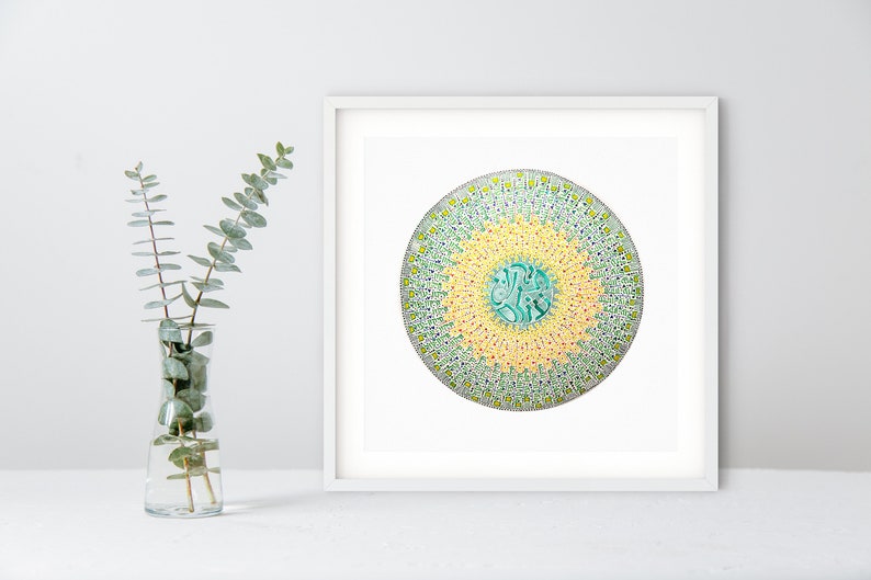 May include: A framed print of a circular mandala design with a green, yellow, and white color scheme. The mandala is surrounded by a white border.