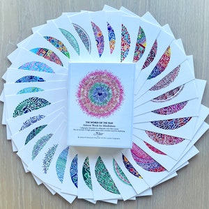 May include: A set of 12 cards featuring Hebrew words for mindfulness, each word is calligraphed in a colorful mandala design. The cards are arranged in a fan shape, with the title card in the center. The title card reads "The Word of the Day: Hebrew Words for Mindfulness".