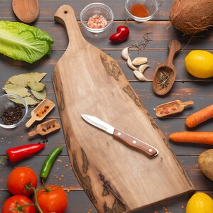 Walnut wood cutting board with bird head shaped handle