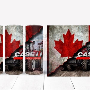 Könnte beinhalten: Ein roter Case IH Traktor mit dem Schriftzug "Case IH Agriculture" an der Seite, teilweise verdeckt von einer abgenutzten kanadischen Flagge mit einem roten Ahornblatt.