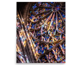 May include: A stained glass window in a church with colorful geometric patterns and light shining through it.