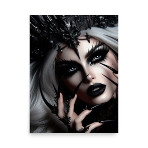 May include: A woman with white hair and dark makeup wears a black crown with spikes and holds her hands up with long, black, sharp nails.
