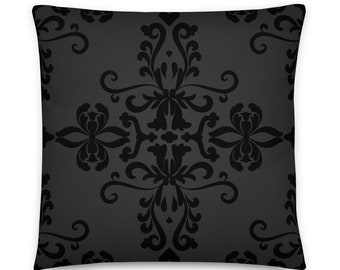 May include: A black and gray throw pillow with a damask pattern.