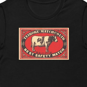 Cow Matchbox etichetta vintage grafica Unisex t-shirt