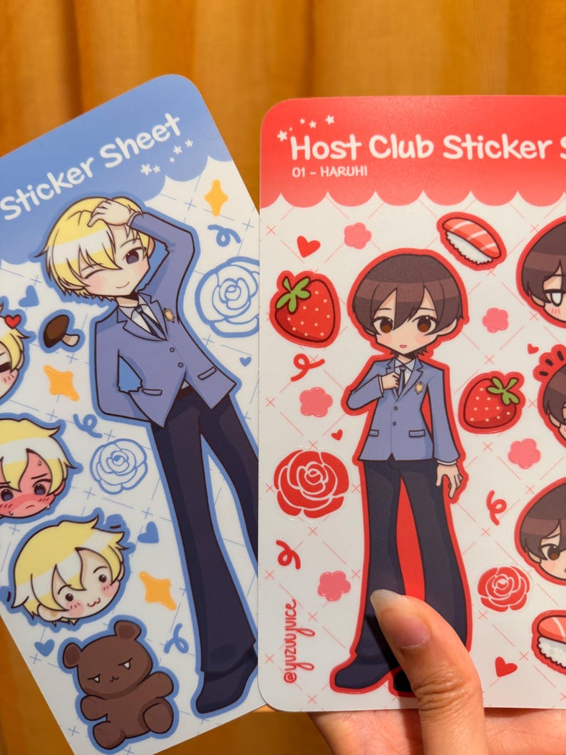 K&ouml;nnte beinhalten: Zwei Stickerb&ouml;gen mit Illustrationen im Anime-Stil. Einer ist blau mit einer blonden Figur und dem Text "Sticker Sheet". Der andere ist rot mit einer braunhaarigen Figur und dem Text "Host Club Sticker S". Beide B&ouml;gen haben zus&auml;tzliche Charakterillustrationen und dekorative Elemente.