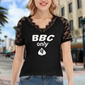 May include: Black t-shirt with lace sleeves and a white graphic that says "BBC only" with a queen of spades symbol.