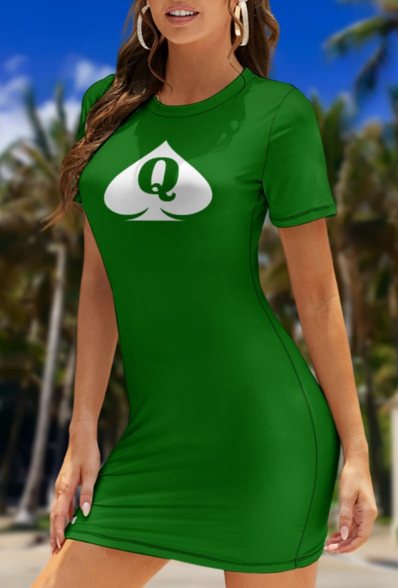 May include: A short-sleeved, form-fitting green dress featuring a white spade symbol on the chest. Inside the white spade, the letter Q is printed in a dark green color. The dress has a round neckline and a simple, clean design throughout.