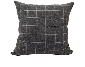 May include: A black and white checkered throw pillow with a subtle sheen. The pillow is made of a soft, textured fabric.