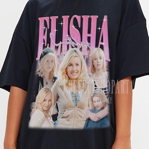 May include: Black t-shirt featuring a vintage-style graphic of the name "ELISHA" in pink, above a collage of five women. The shirt is a classic crew neck style.