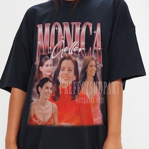May include: Black oversized t-shirt with a graphic print of Monica Geller from the TV show Friends. The graphic features a collage of Monica's face in different poses with the text "Monica Geller" in a red and pink font.