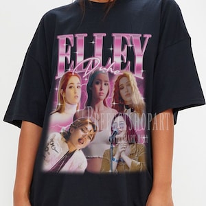 May include: Black oversized t-shirt with a graphic print of a group of women with the text "ELLEy Duh" in pink.