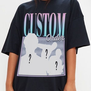 May include: Black oversized t-shirt with a graphic print of two figures in silhouette with the text "CUSTOM Order" above them.