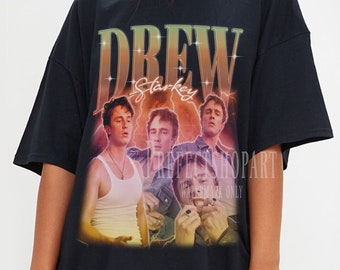May include: Black oversized t-shirt with a graphic print of a band called "Drew Starkey".