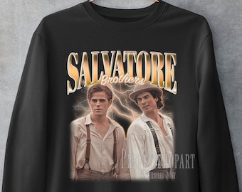 May include: Black sweatshirt featuring a vintage-style graphic of two men with the text "Salvatore Brothers" in gold lettering. The image has a retro aesthetic with lightning bolt accents.