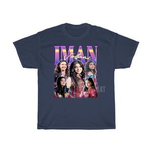 May include: A navy blue t-shirt with a retro-style graphic featuring a group of young women with the text "Iman Villane" in a colorful, stylized font.