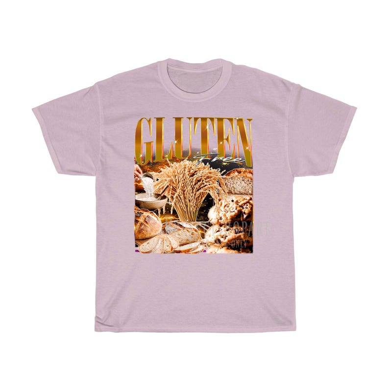 May include: A lilac t-shirt with a gold-coloured "GLUTEN" graphic above an image of bread and wheat. The words "gluten free" are also visible. The design suggests a theme of gluten-free food.