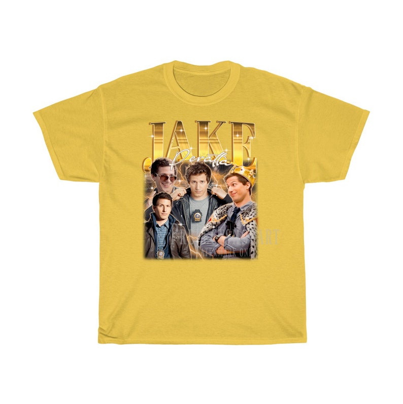 May include: Yellow t-shirt with a retro-style graphic of Jake Peralta from the TV show Brooklyn Nine-Nine. The graphic features Jake Peralta in different poses with the text "JAKE PERALTA" in gold letters.