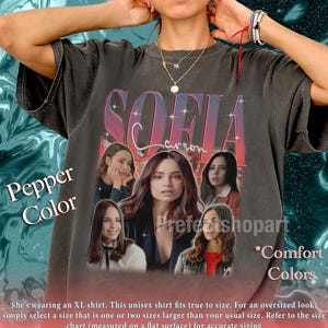 May include: Pepper-colored unisex t-shirt featuring a graphic of the name "SOFIA" and multiple images of a woman. The shirt also has the text "Comfort Colors" and "Prefectshopart".