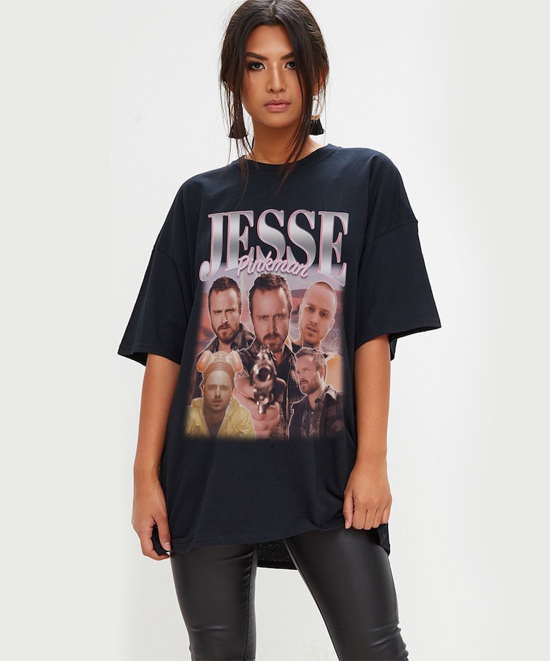 May include: Black oversized t-shirt with a vintage-style graphic print of Jesse Pinkman from the TV show Breaking Bad. The print features multiple images of Jesse Pinkman, including one with a gun.