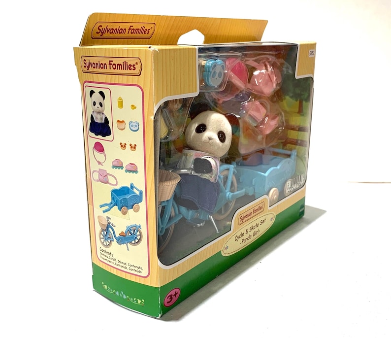 May include: A Sylvanian Families Cycle & Skate Set Panda Girl toy in a cardboard box. The set includes a flocked panda figure, a light blue bicycle with a front basket, a matching light blue trailer, pink roller skates, and various accessories.