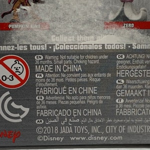 May include: A product package with text in multiple languages, including English, French, and Spanish. The package includes a warning about small parts and choking hazards, and states "Made in China". The Disney logo is visible.