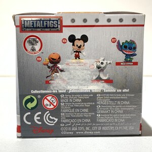 May include: A box featuring Disney characters from the Metalfigs collection. The box displays images of Mickey Mouse, Jack Skellington, Zero, and Stitch. The box has the Metalfigs logo and the Disney logo.