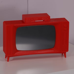 May include: A red vintage-style television set with a matching red box on top. The television has a black screen and a silver knob on the side.