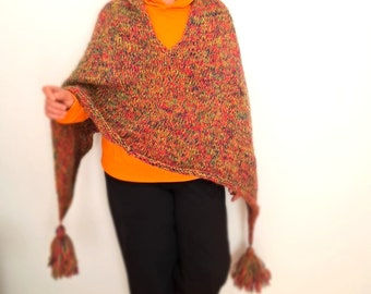 May include: A multi-colored knitted poncho with tassels. The poncho is made of a soft, chunky yarn and has a loose, flowing fit. The poncho is a great way to add a touch of warmth and style to any outfit.