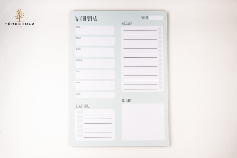 May include: A light blue weekly planner with sections for meals, tasks, birthdays, and notes. The planner has the text "Wochplan" at the top.