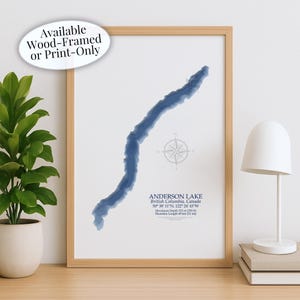 May include: A framed print of Anderson Lake in British Columbia, Canada. The lake is depicted in shades of blue, with a compass rose and location details. The text "Available Wood-Framed or Print-Only" is in the upper left corner.