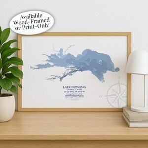 May include: A framed print of Lake Nipissing, Ontario, Canada, in shades of blue. The map includes the lake's coordinates, average depth of 5 m, and maximum depth of 64 m. The text "Available Wood-Framed or Print-Only" is in the upper left corner.