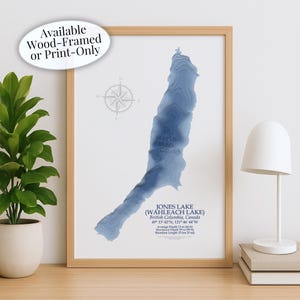 May include: A framed print of Jones Lake (Wahleach Lake) in British Columbia, Canada, with a blue topographic map design. The print includes the lake's coordinates, average and maximum depths, and shoreline length. The frame is wood.