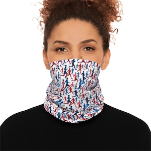 May include: A white neck gaiter featuring a pattern of red and blue running figures. The gaiter is worn around the neck and covers the lower face. The person in the image is wearing a black top.