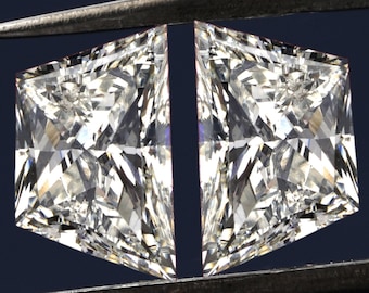 May include: Two clear princess-cut diamonds held by a pair of tweezers against a dark blue background.