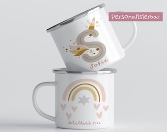 May include: Two white enamel mugs with personalized designs. The top mug features a unicorn with a gold horn and stars, with the name "Sofie" written below. The bottom mug has a rainbow with pink and gold accents, a star, and hearts, with the text "Schulkind 2022". The text "Personalisierbar" is visible in the top right corner.