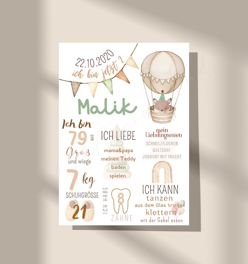 May include: A colorful printable chart for a baby's first year milestones. The chart features a cute fox in a hot air balloon, with details like the baby's name, Malik, birthdate, height, weight, shoe size, and the number of teeth. The chart also includes a list of things the baby can do, such as dance, drink from a glass, climb, and eat with a fork.